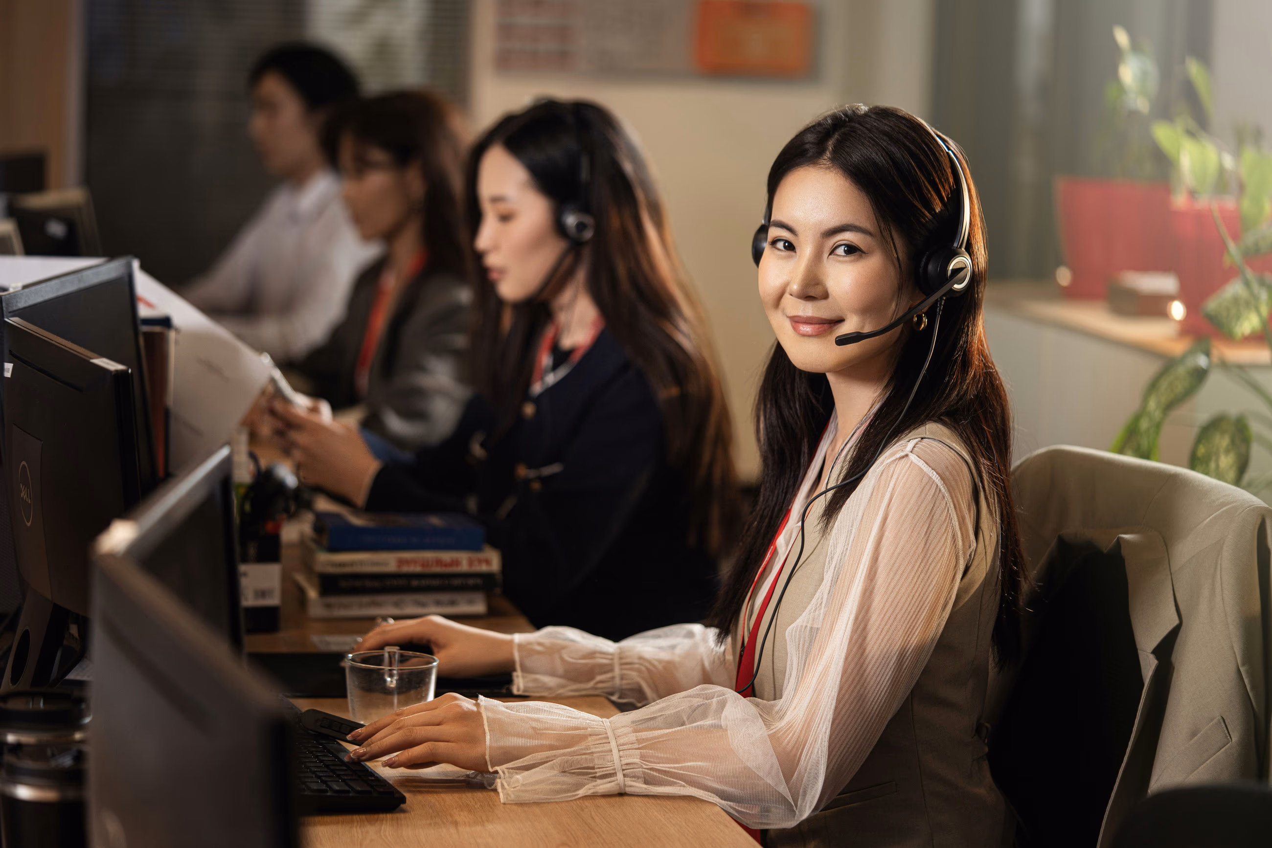 A dental admin at her workstation, headset on, taking a call